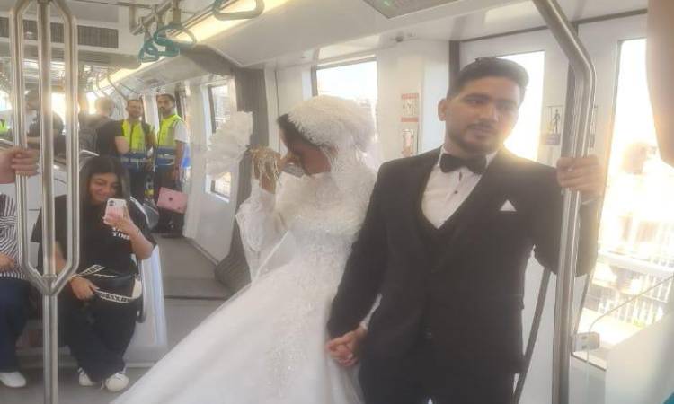 Couple in wedding attire inside the monorail